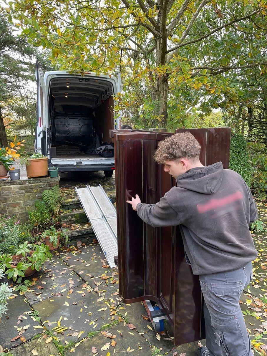 Loading a piano into the van in Salford